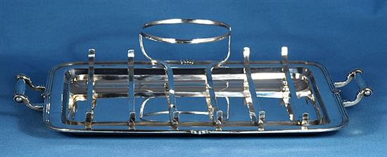 A 1930s silver asparagus draining dish with asparagus servers and sauce boat, by Goldsmiths & Silversmiths Co, tray length